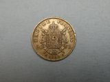 a close up of a gold coin with a coat of arms on it