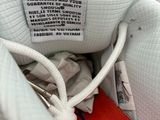 the shoe is white and has a red stripe on the side