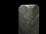 an image of a green marble pedestal on a black background