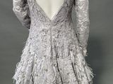 the back of a mannequin dress with feathers on a mannequin mannequin