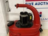 an image of a red vacuum cleaner sitting on top of a table