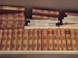 many books that are on a shelf in the room