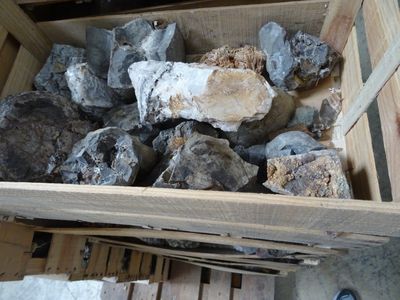 a wooden box filled with rocks and wood planks