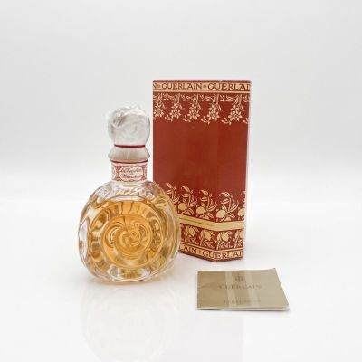 an image of a bottle of perfume sitting next to a box