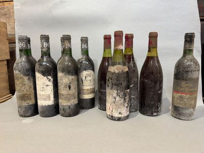 bottles of wine are lined up on a table in front of a white backdrop