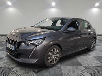 the grey car is parked on a checkered floor in a garage
