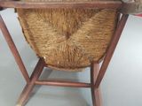 a wicker basket on a wooden stand on the floor