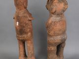 two clay figurines of a man and a woman