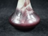 a glass vase with a design on it on a black surface