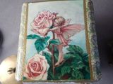 a small box with a painting of a fairy on it