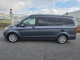 the grey van is parked in a parking lot near a building