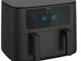 the air fryer is black and has a digital clock on it
