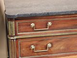 a wooden dresser with a marble top and brass handles