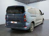 the rear end of a blue van parked in a garage
