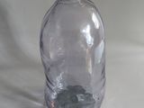 a clear glass bottle with a rock inside of it