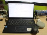 a laptop computer sitting on top of a desk next to a mouse