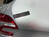 a sticker on the back of a white car