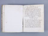 an open book with writing on it sitting on top of a table