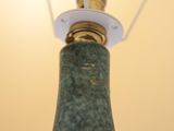 a lamp that has a green marble base on it