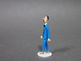 a small figurine of a man in a blue suit