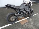 a black motorcycle parked in a parking lot next to a building
