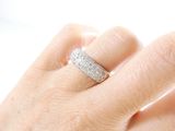 a woman ' s hand with a diamond ring on it