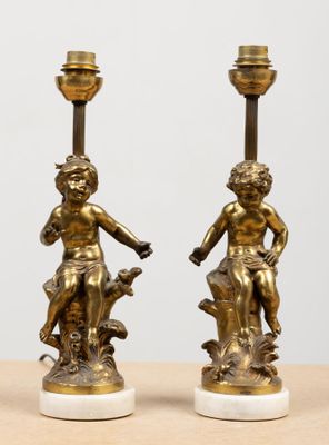 pair of antique bronze figurines of a boy and a girl on marble bases