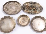 four silver dishes and a bowl on a white surface