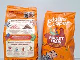 two bags of dog food sitting next to each other on a table