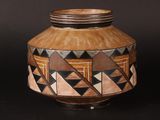 a brown vase with black and white designs on it