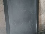 a blackboard on the floor next to a trash can