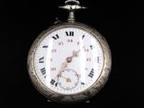 a silver pocket watch with roman numerals on it