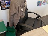 a person sitting at a desk with a backpack on it
