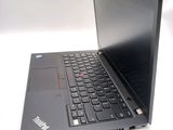 a black laptop with a red button on the keyboard