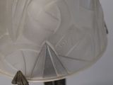 a close up of a lamp with a white shade on it