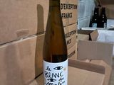 a bottle of wine sitting on top of a cardboard box