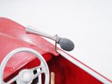 a red toy car with a steering wheel and a microphone