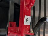 a red fire hydrant with a hose attached to it
