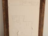 an old picture frame with a drawing of a kitchen and a living room