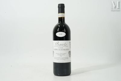 the bottle of wine is sitting on a white surface