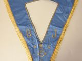 a close up of a blue and yellow sash with gold trim