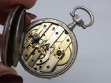 a close up of a person holding a pocket watch