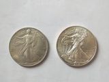 two quarters of the same type of coin are shown on a white surface