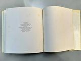 an open book with a poem on it on a table