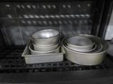 pots and pans are sitting on a tray in an oven