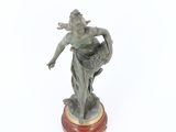 a statue of a woman holding a basket of flowers