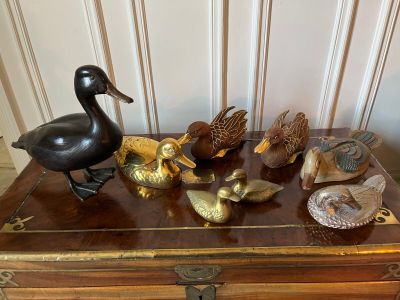 a wooden chest with a bunch of birds on top of it