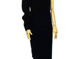 an image of a mannequin wearing a black dress on a wooden stand