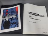 an open book with a picture of a man walking down a street