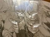 three wine glasses sitting on a marble table